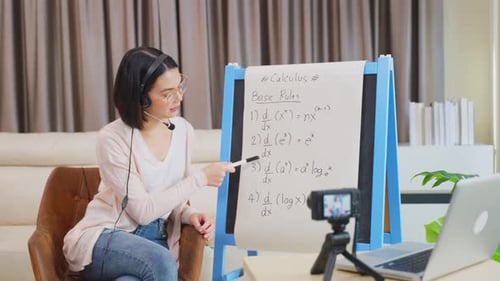 Asian school young woman teacher working from home teach online math subject to student at home.