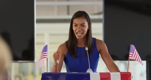 Woman Speaking at Podium with American Flags