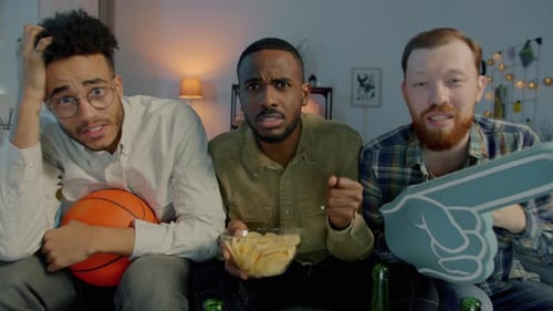 Portrait of Emotional Sports Fans Watching Basketball Game on TV at Home Screaming Crying Over