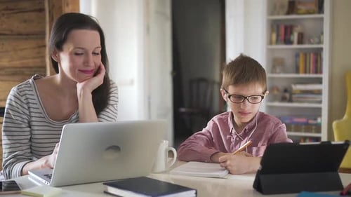 Woman and Child Working at Table at Home