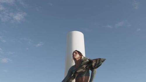 Woman with Long Hair Twirling Item in Urban Area