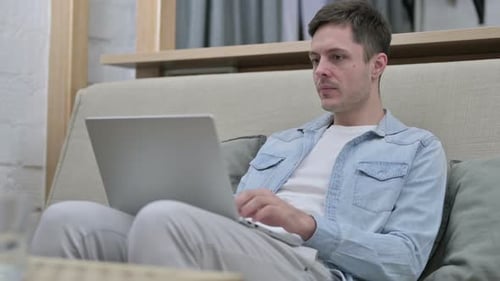 Young Man Closing Laptop and Leaving Room