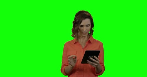 Woman Using Tablet on Green Screen