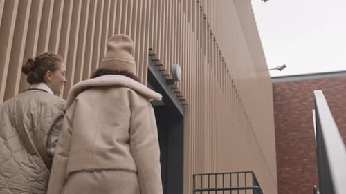 Stylish Young Women Walking up Urban Steps