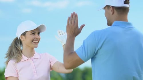 Golfers Give High Five in Daylight