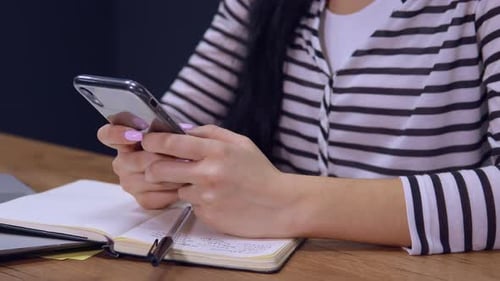 Close Up Female Typing Message on Mobile at Work