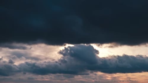 Dramatic Clouds Passing Over Vibrant Sunset Sky