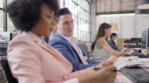 Coworkers Working Together at Bright Office Workplace