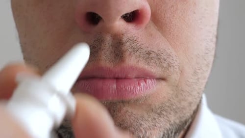 Man Using Nasal Spray Close Up