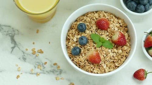 Granola with Berries and Juice for Breakfast