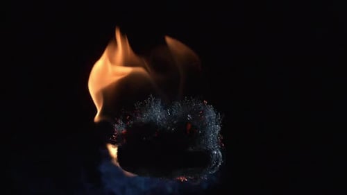 Burning Material with Flames on Black Background