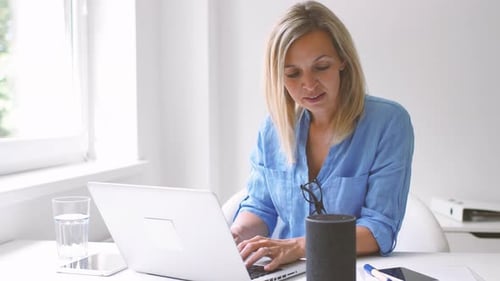 Woman Typing at Desk with Computer and Technology
