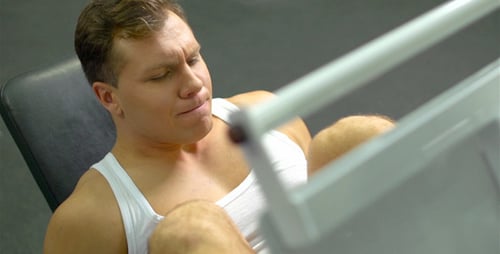 Man Doing Leg Press in a Gym