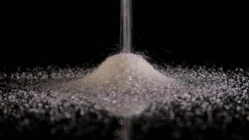 Sugar Pile Forming on Black Background