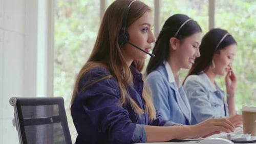 Customer Support Agent or Call Center with Headset Talking to Customer on Phone