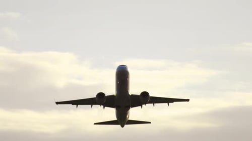 Commercial Airplane Ascending into a Bright Sky