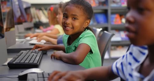 Side view of mixed-race schoolkids studying on computer in the classroom 4k