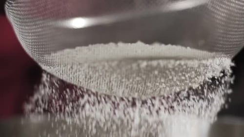 Close-up of Flour Through Sieve Fray. Sifting Flour. Slow Motion Shot