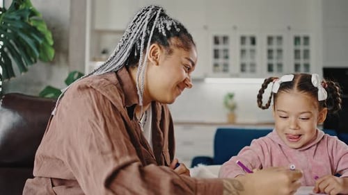Woman Drawing with a Child at Home