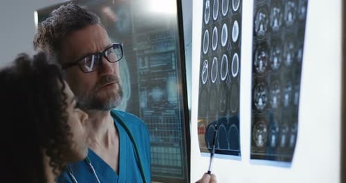 Medical Professionals Reviewing Brain Scans in Office