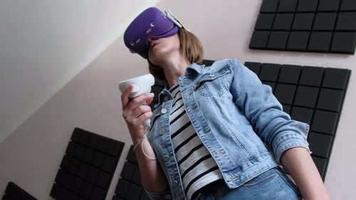 Woman Experiencing Virtual Reality with Headset and Controller
