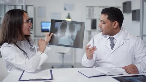 Doctors Reviewing X-Ray in Office Setting