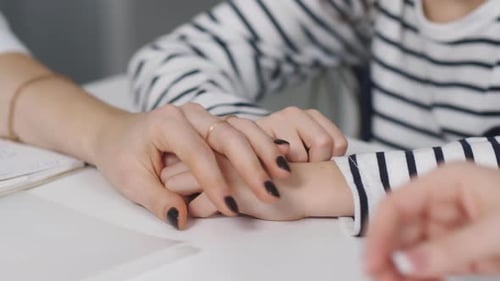 Adult and Child Holding Hands for Comfort