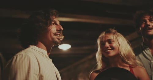 Friends Gathering Together Indoors Smiling and Chatting