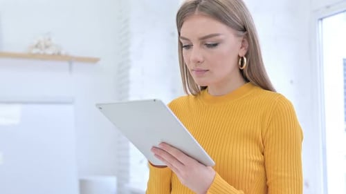 Woman Using Tablet Device Smiling Indoors