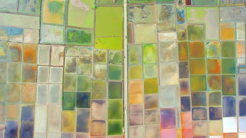 Aerial view flying over a beautiful colorful natural sea salt pond