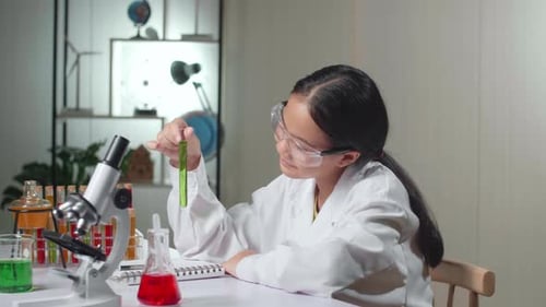 Child Scientist Examining Test Tube in a Lab