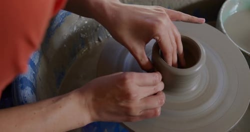 Young female potter working in her studio