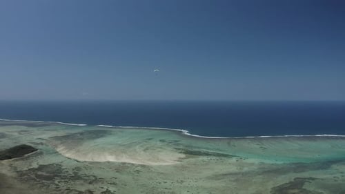 Luftaufnahme einer Person beim Gleitschirmfliegen zwischen den Bergen, Mauritius.