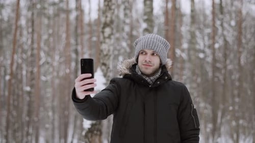 Man Takes Selfie in Snowy Winter Forest