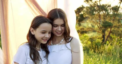 Two Girls Smiling Together in a Rural Setting