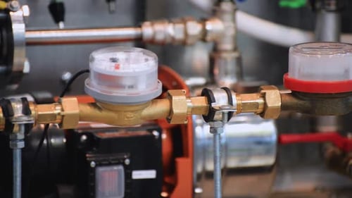 Close-up of Interconnected Pipes and Water Meters