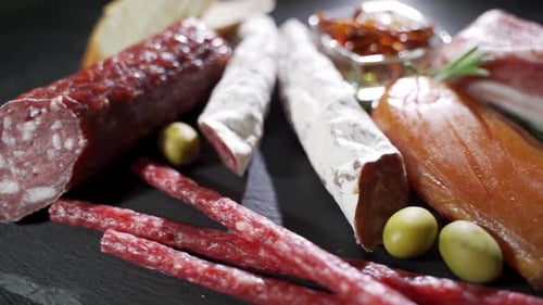 Assorted Cured Meats, Olives, and Peppers on Display