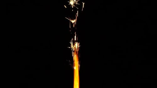 Bright Sparkler Emitting Hot Yellow Sparks on Black