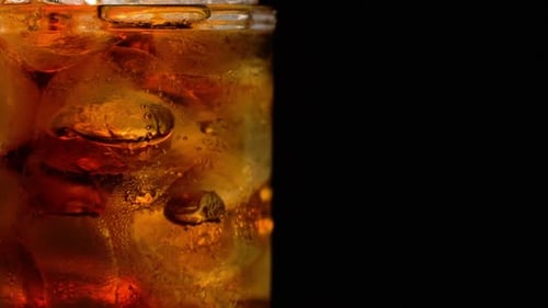 Refreshing Soda with Ice in Glass Close Up