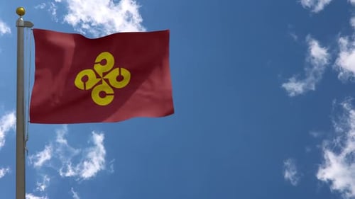 Red Flag with Yellow Abstract Symbol Waving in Blue Sky