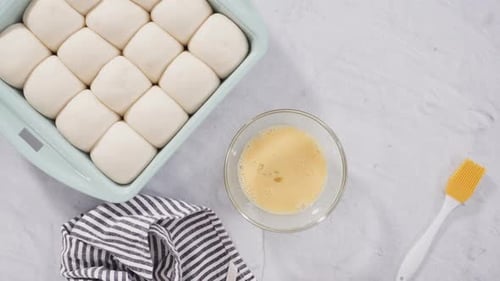 Dinner Rolls Being Brushed With Egg Wash