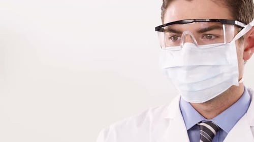 Scientist Inspects Test Tube with Red Liquid