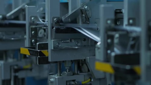 Automated Machine Manufacturing White Tapes in Close Up