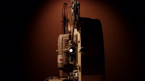 Vintage Film Projector Illuminated in Dark Room