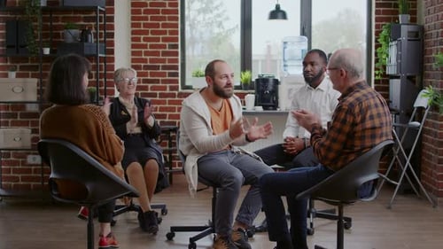 Diverse Group Clapping in a Therapy Session