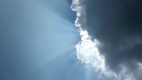 Sunlight Through Clouds in Blue Sky