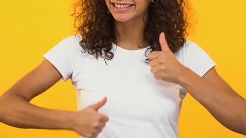 Smiling Young Woman Giving Two Thumbs Up