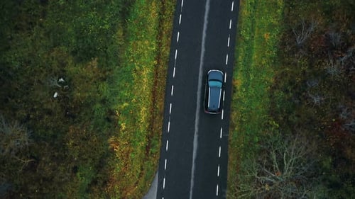 Scenic Aerial Top View Close-up, Drone Tracking Black SUV Car Moving Along Highway Road
