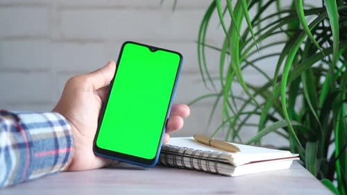 Close Up of Young Man Hand Using Smart Phone with Green Screen