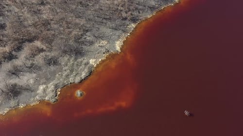 Acid Mine Drainage AMD lake from open mine pit 4K aerial video